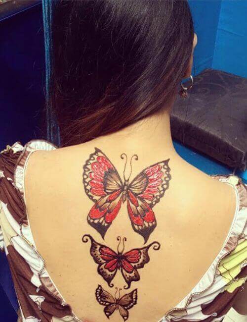 Black salve butterfly tattoo