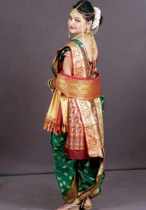 The rani pink with green contrast Boarder in nauwari stitched Paithani Art  Silk Saree.
